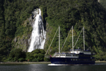 Bowen Falls and a tourist boat in Milford Sound
